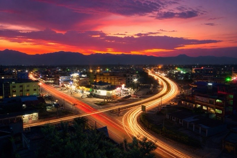 Twilight view of the BP Highway in Bardibas with mountains and a warm sunset sky