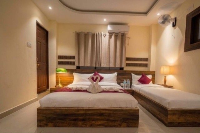 Family room with double and single beds at Akabare Inn